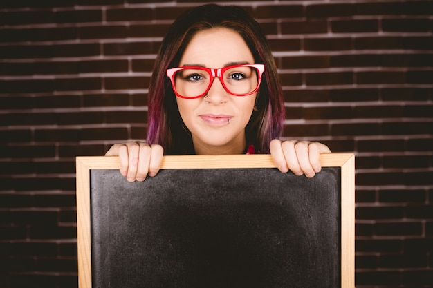 Portrait of smiling woman holding slate