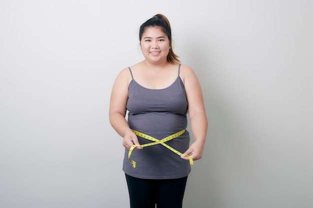 Portrait Of Smiling Woman Holding Tape Measure White