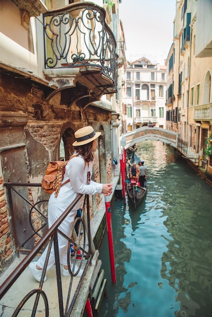 Portrait of smiling woman looking at canal with gandola summer vacation