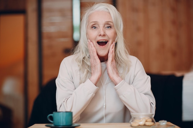 Portrait of smiling woman making face at cafe