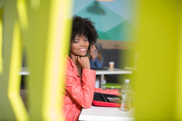 Portrait of smiling woman in office lounge