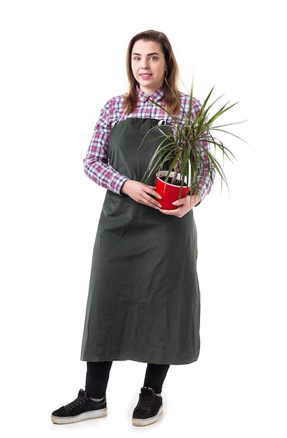 Портрет улыбающейся женщины, профессионального садовника или флориста в фартуке, держащей цветы в горшке на белом фоне