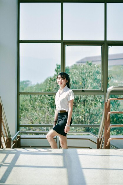 Portrait of smiling woman seen through glass window