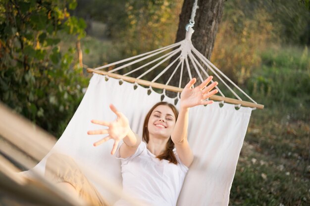 Foto ritratto di una donna sorridente seduta su un'amaca