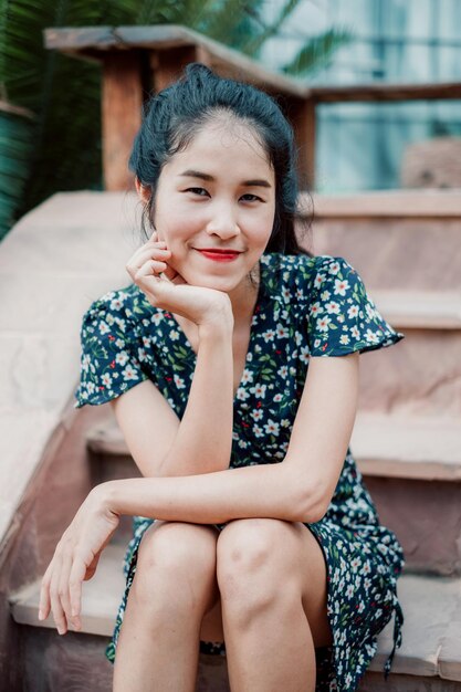 Portrait of smiling woman sitting on staircase