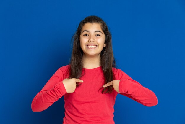 Portrait of smiling woman standing against blue background