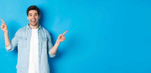 Portrait of smiling woman standing against blue background