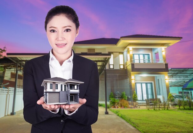 Portrait of smiling woman standing against building