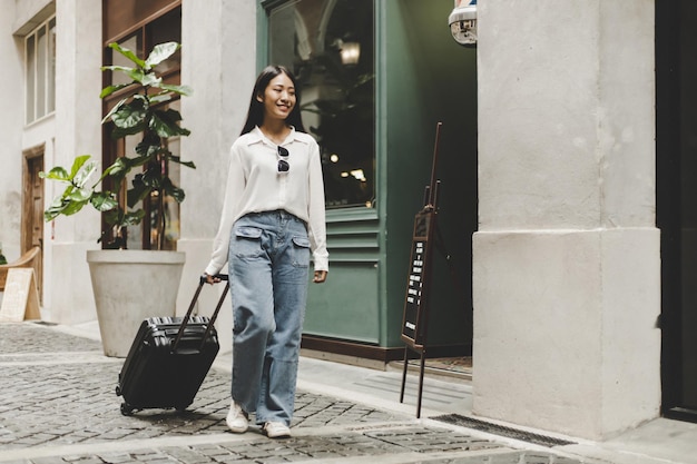 portrait of smiling woman standing against wall