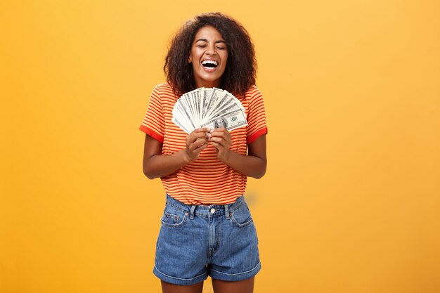 Portrait of smiling woman standing against yellow background