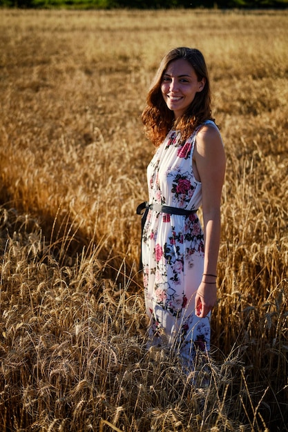 Portrait of smiling woman standing on field