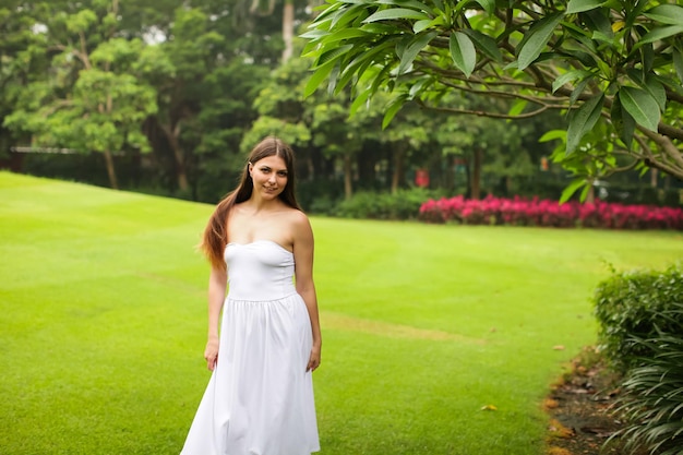 Portrait of smiling woman standing in park