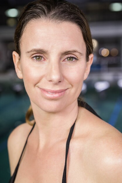 Portrait of smiling woman at the swimming pool