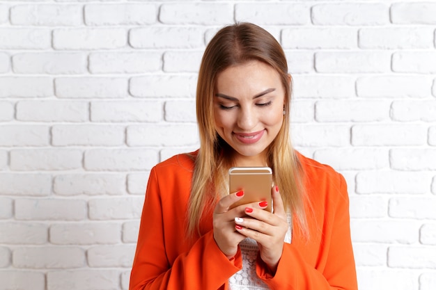 Portrait of a smiling woman using smartphone