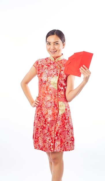 Portrait of smiling woman wearing traditional clothing holding envelopes against white background