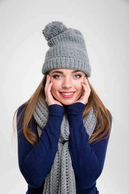 Portrait of a smiling woman in winter cloth looking at camera isolated on a white background