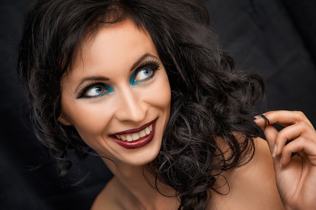 Portrait of smiling woman with bright make-up , brunette