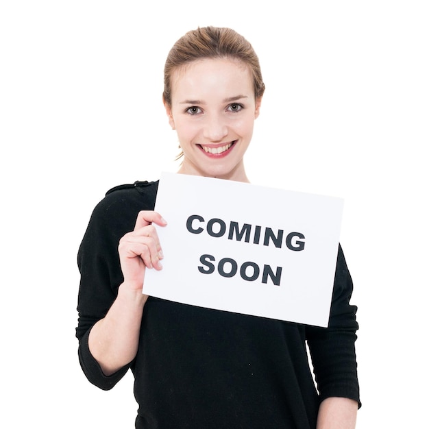Photo portrait of smiling woman with coming soon text on paper against white background