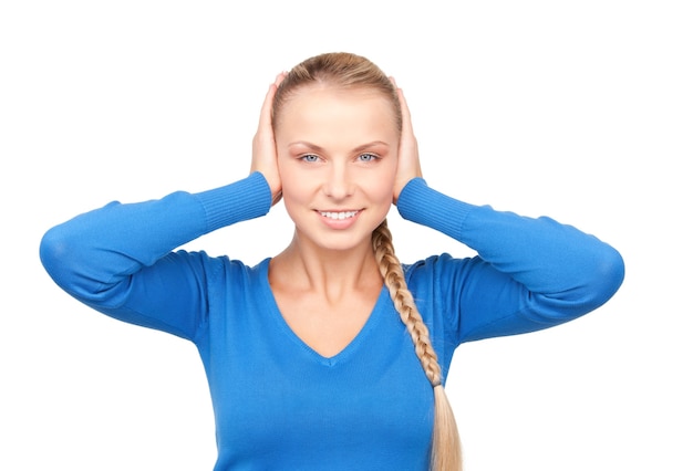 Portrait of smiling woman with hands over ears