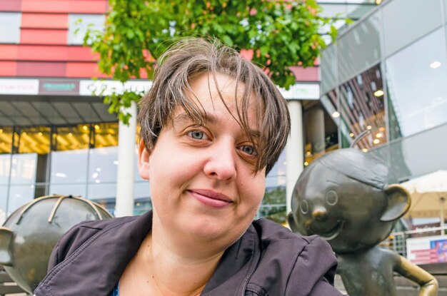 Portrait of smiling woman with short hair in city