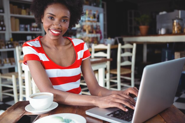 Portrait of smiling woman working on laptop