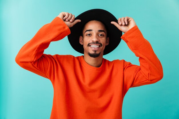 Portrait of a smiling young afro american man in hat