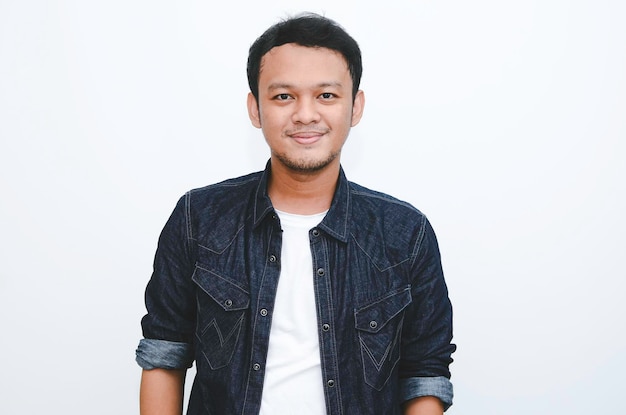 Portrait of smiling young asian man wearing white shirt and denim pant isolated on white