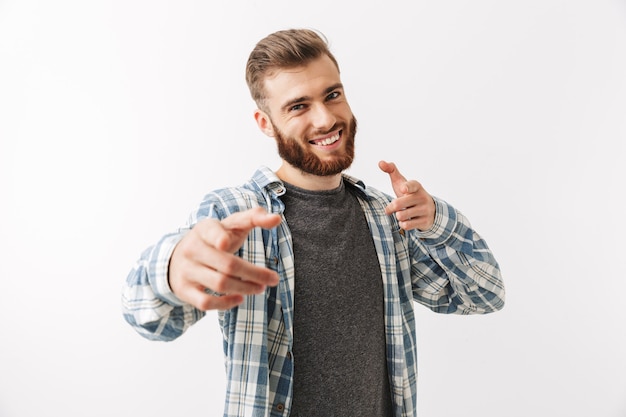 Portrait of a smiling young bearded man standing