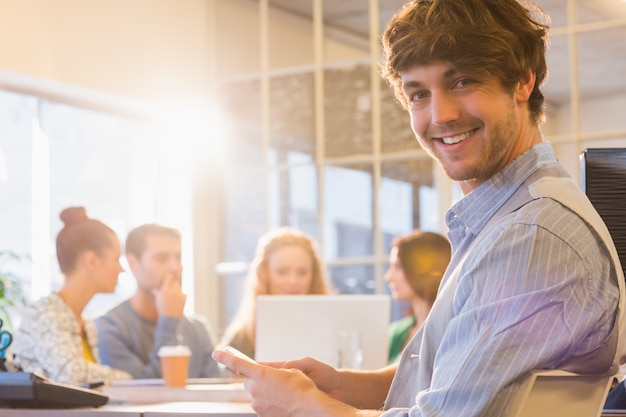 Portrait of smiling young businessman with colleagues 