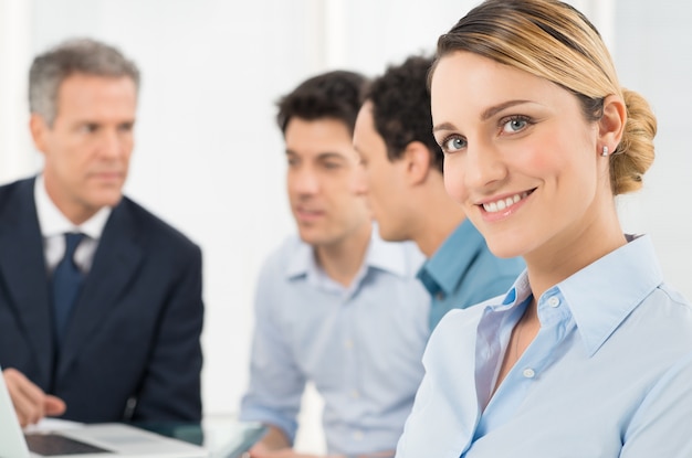 Portrait Of Smiling Young Businesswoman In Front Of Her Colleague