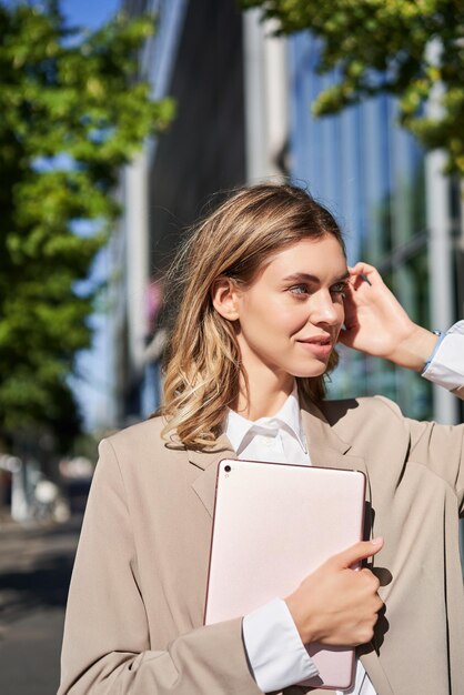 Portrait of smiling young businesswoman standing outdoors