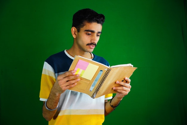 Portrait of smiling young college student with books