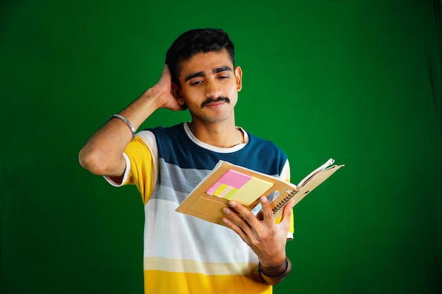 Portrait of smiling young college student with books