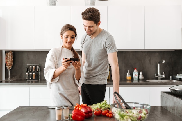 Portrait of a smiling young couple cooking together