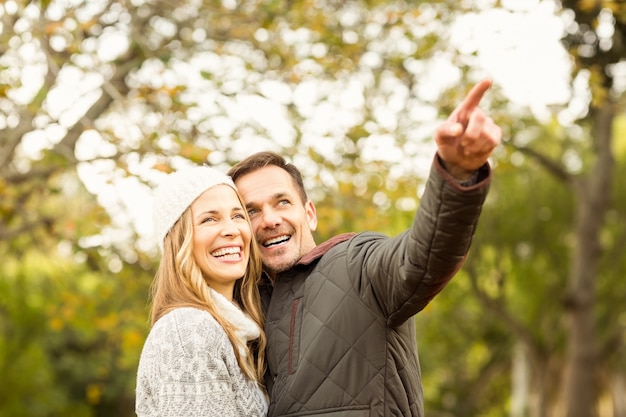 Portrait of smiling young couple pointing something