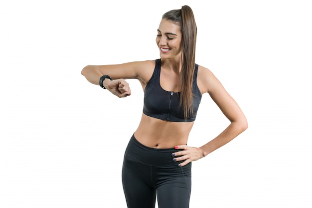 Portrait of smiling young female looking at wrist watch