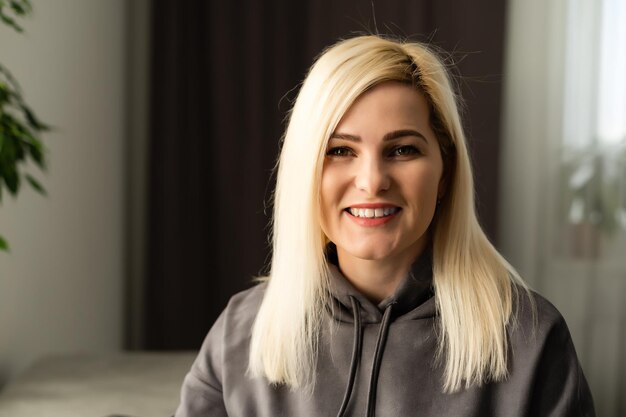 Portrait of a smiling young lady looking at camera, head shot