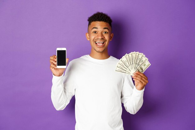 Portrait of a smiling young man against blue background