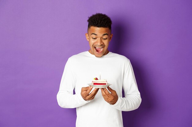 Portrait of a smiling young man against colored background