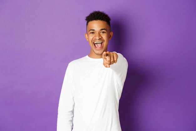 Portrait of a smiling young man against colored background