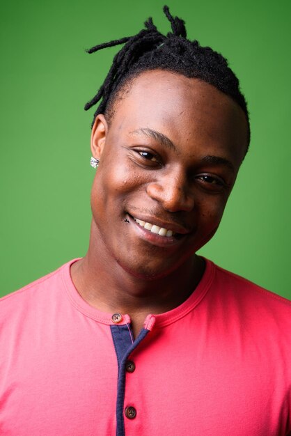 Portrait of smiling young man against gray background