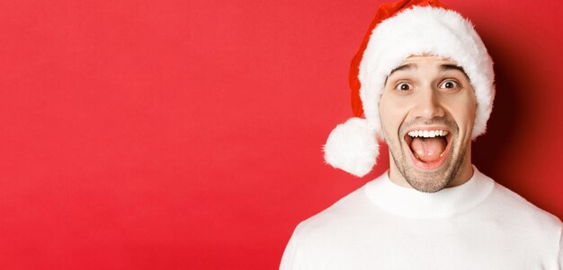 Portrait of a smiling young man against red background