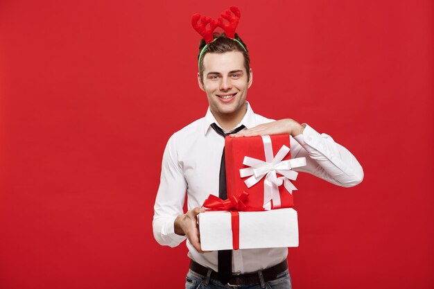 Portrait of a smiling young man against red background