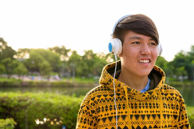 Portrait of smiling young man against sky