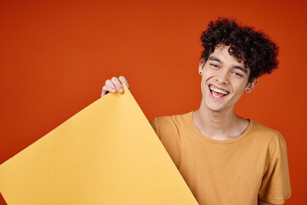 Portrait of smiling young man against wall