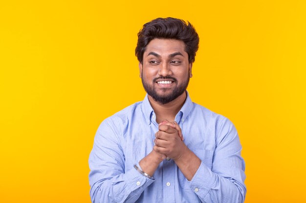 Portrait of a smiling young man against yellow background