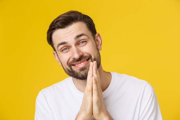 Portrait of smiling young man against yellow background