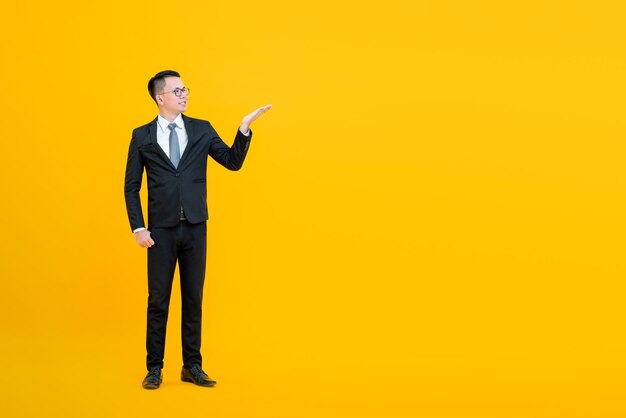 Portrait of a smiling young man against yellow background