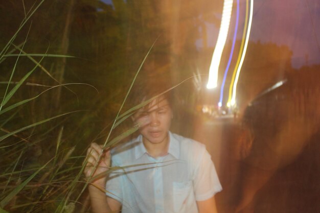 Portrait of smiling young man at night