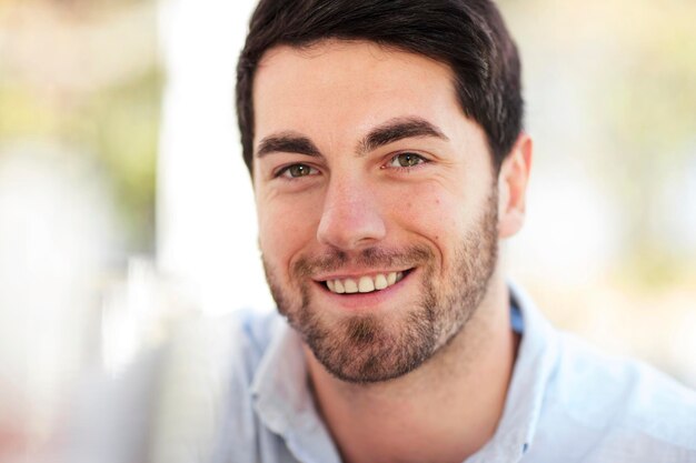 Portrait of smiling young man outdoors